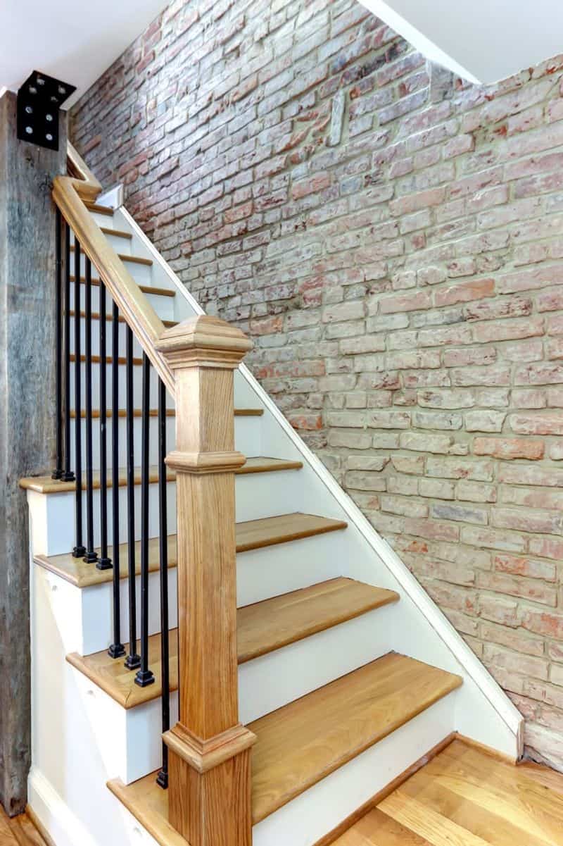 Wooden Staircase with Brick Accents